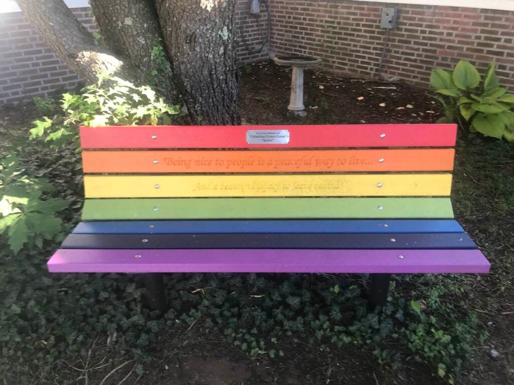 A bench painted in rainbow colors.